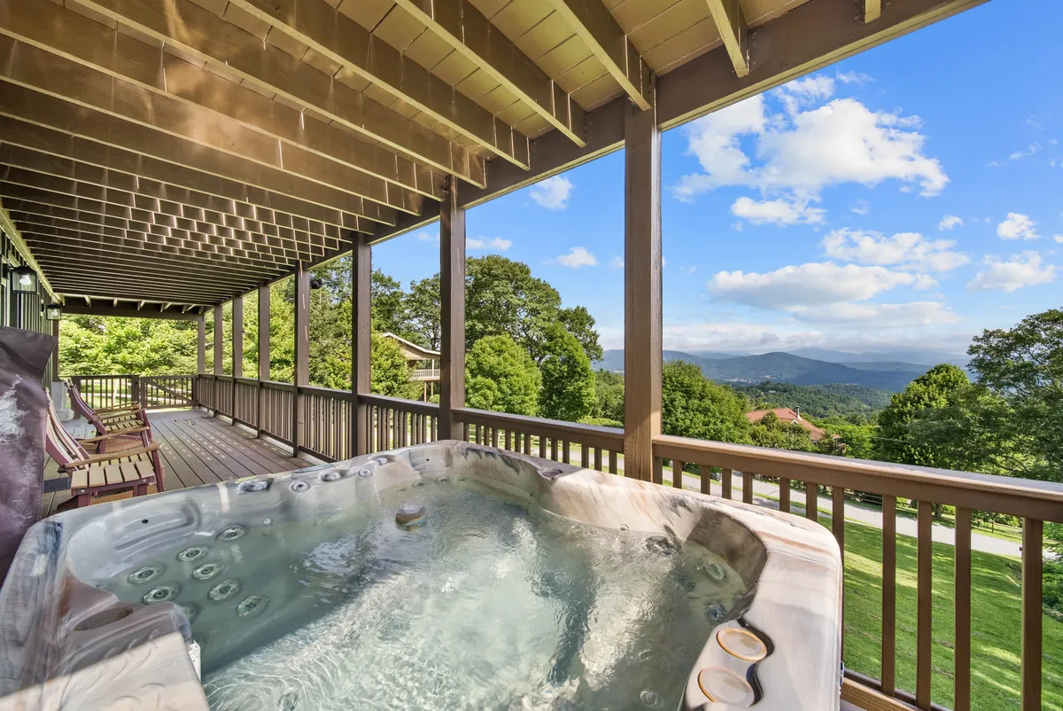 A tranquil deck scene featuring a hot tub overlooking breathtaking scenery, with outdoor seating and thoughtful amenities that invite relaxation and reflection.